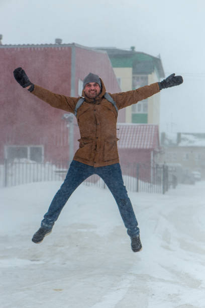 istock Winter is coming by severe blizzard. Poor visibility in heavy snow storm on path. Man slowly and hard walking in dangerous weather day. Cataclysm of nature. City people life in blizzard concept. 1789148323