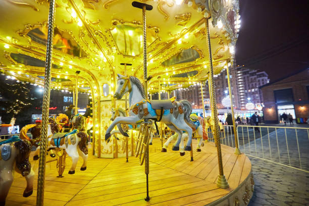 istock A carousel with horses at night in a crowded city. 1789162808