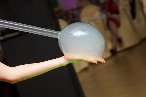 Soap bubbles at a children's party. Entertainment for children