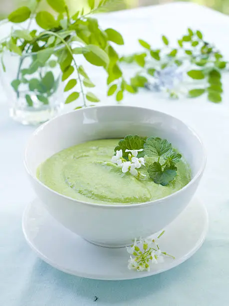 Pea cream soup in bowl, selective focus