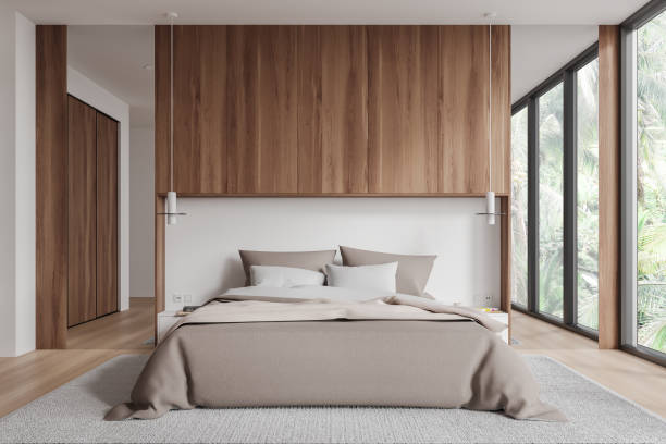 istock Wooden hotel bedroom interior with bed, decoration and panoramic window 1789168852