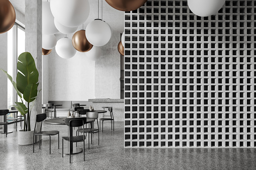 Interior of modern loft restaurant with white and geometric pattern walls, concrete floor, bar counter, round tables with chairs and creative balloon like lamps. Copy space wall on the right. 3d rendering