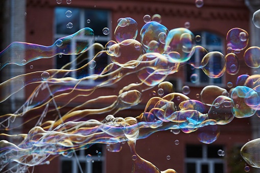 Bright soap bubbles on the city street. Close-up. The concept of a holiday and entertainment.