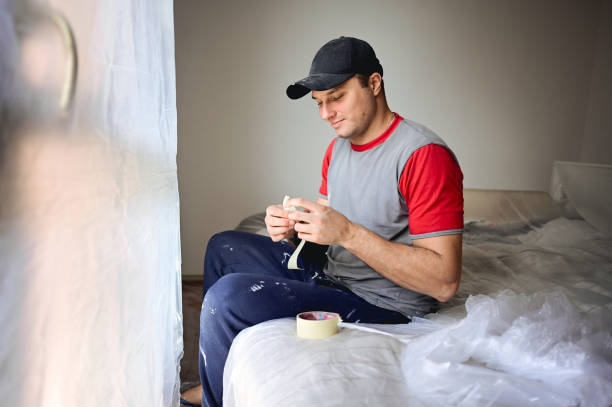 istock house painter preparing the room for painting a wall. 1789198134