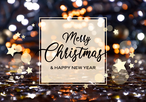 Merry Christmas & Happy New Year inscription in a frame on a shiny golden starry bokeh background stock images