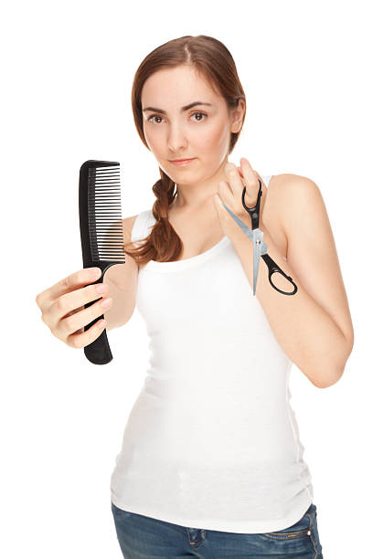 Hairdresser holding a  scissors and comb isolated on white focus on comb)