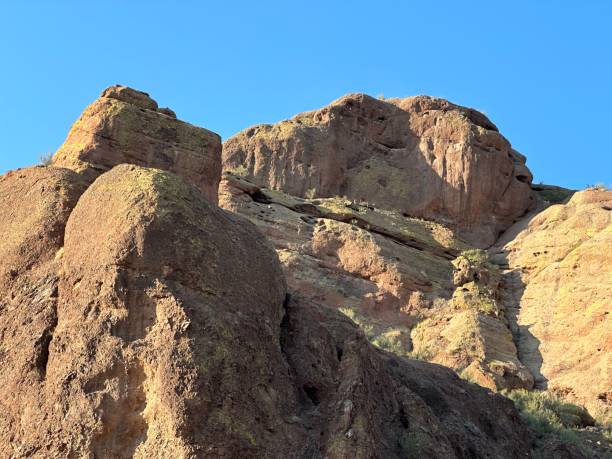 istock people in blue vests climbing up a large rock wall 1789222323