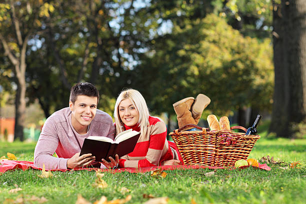 istock Loving couple reading a book in park 178923733