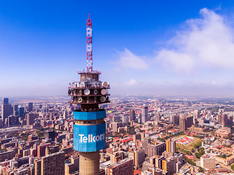 Close up view of Telkom telecommunications tower in the urban residential area of Hillbrow in Johannesburg with many skyscraper apartment blocks.