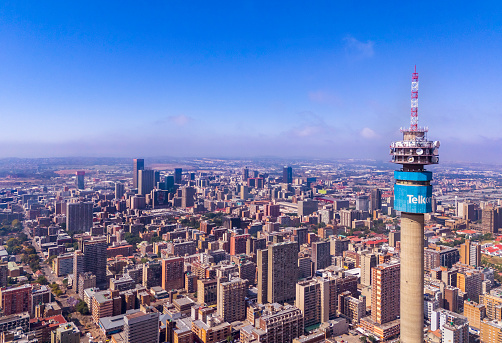 Telkom telecommunications tower in the urban residential area of Hillbrow in Johannesburg with many skyscraper apartment blocks.