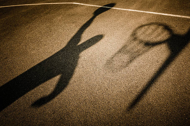 istock Shadow of basketball player slam dunking ball 178927712