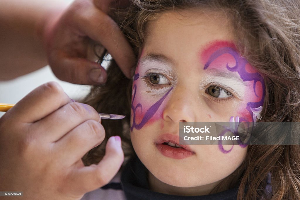 Face Painting A girl has her face painted in California, USA Child Stock Photo