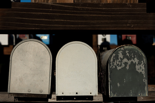 Rows of metal, round-topped , colorfully-painted mail boxes.