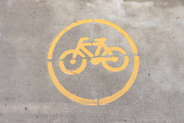 Bicycle lane sign on concrete surface. yellow Bicycle sign on road.