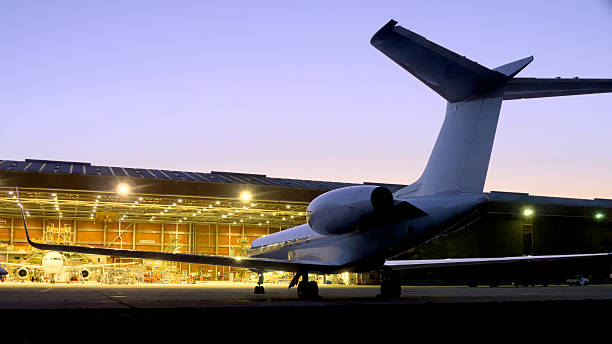 Small jet at airport hanger