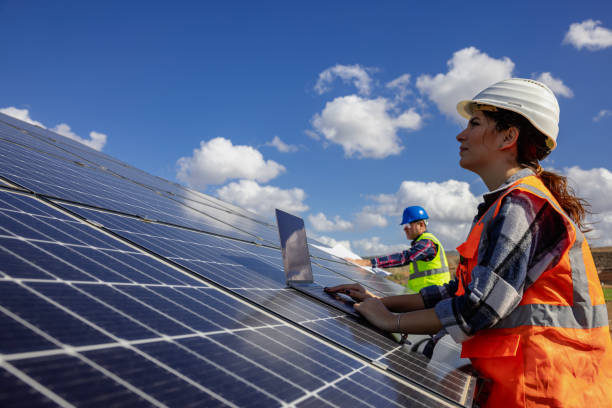 Solar panel and engineer workers working on a farm on clean electricity. stock photo