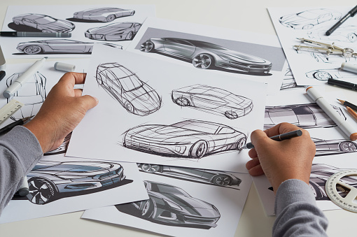 Designer engineer automotive designÂ drawing sketch development Prototype concept car industrial creative.