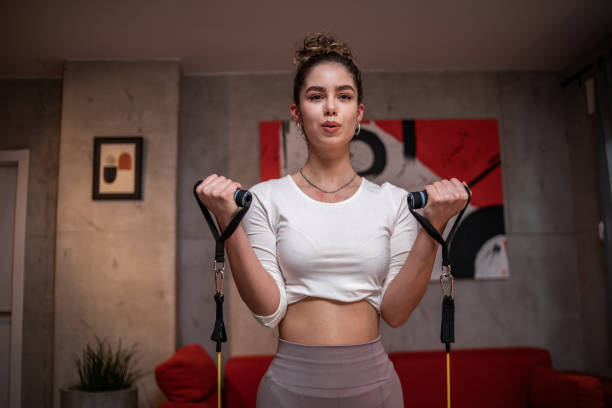 istock One young woman athlete doing exercises using rubber resistance bands 1789426994