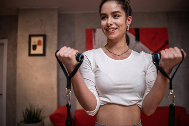 istock One young woman athlete doing exercises using rubber resistance bands 1789426995
