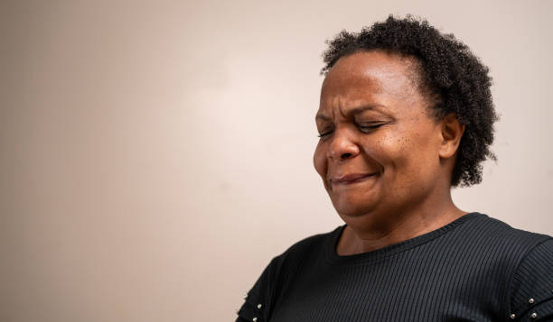 istock Black woman with eyes closed with sad expression on pastel background. 1789450709