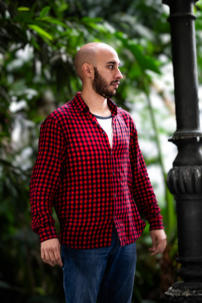 istock Portrait: Bald, bearded tourist, gazes away, exploring Madrid with bokeh background. 1789451230