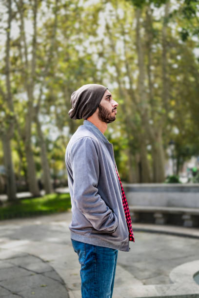 istock Profile with a red-checkered shirt, thoughtful look, Madrid autumn park backdrop. 1789451821