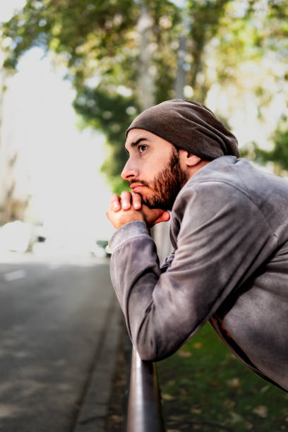 istock Street-style guy looking aside, autumn vibes, Madrid roadside exploration. 1789452332