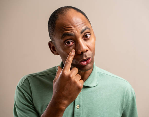 istock Man pointing to his eye on a pastel background. 1789453483
