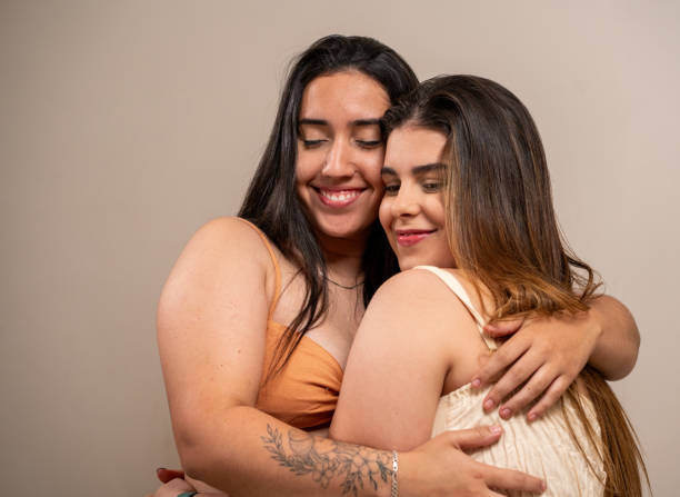 istock Smiling young women hugging each other on pastel background. 1789456748