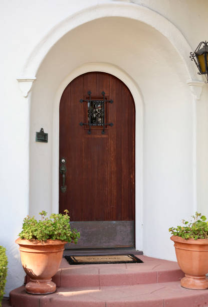 istock 1920s bungalow with arched front door and rounded patio 1789459444