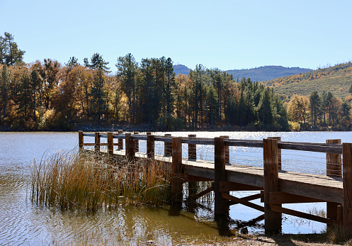 Wood dock on a peaceful quiet lake in autumn