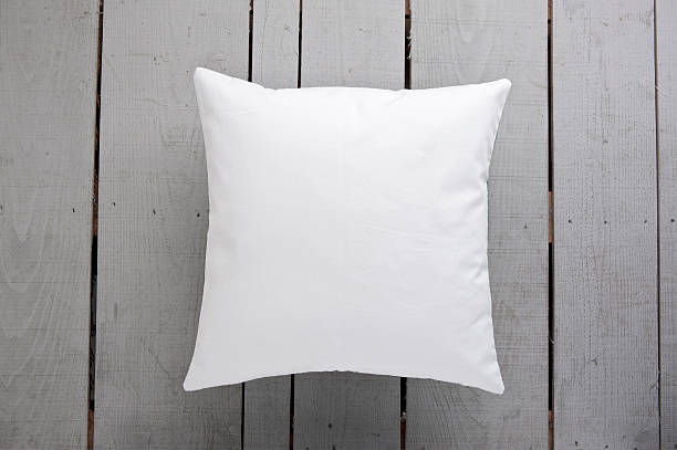 White cushion on wooden background stock photo