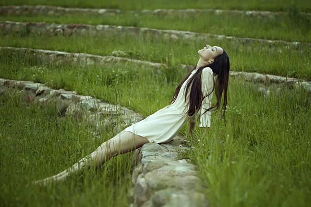 Young  woman in green field stock photo