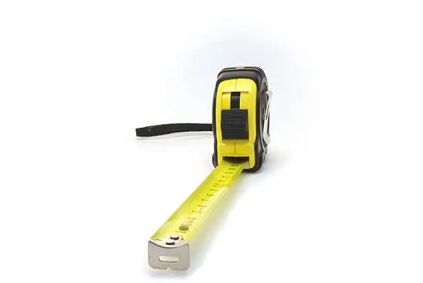 Yellow tape measure on the white background.