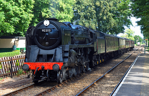 Holt, Norfolk, England - July 10, 2023: Vintage British Railways BR Standard Class 9F 2-10-0  steam locomotive  