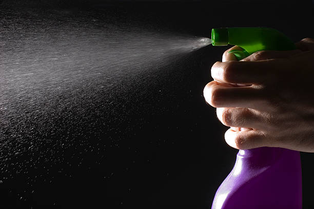 istock Green and purple spray bottle spraying liquid 178953334