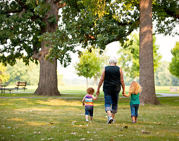 istock Girls & Grandma Walking in Park 178953482
