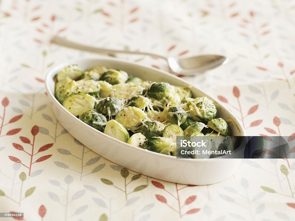 Roasted Brussels Sprouts "Roasted bussels sprouts with melted cheese, on patterned tablecloth." Brussels Sprout Stock Photo