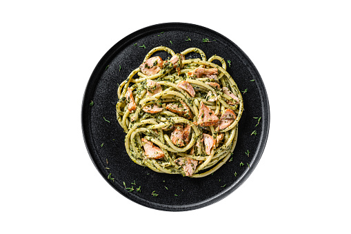 Bucatini Pasta with Smoked Salmon fillet and creamy spinach.  Isolated, white background. Top view