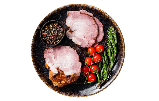 Smoked pork meat - gammon with herbs on rustic plate.  Isolated, white background. Top view