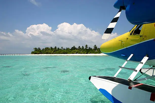 Seaplane before the Angaga island in the Maldives in the Indian Ocean.