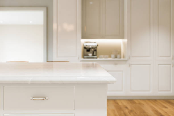 istock Kitchen white countertop with white marble, with blurred bokeh background. Presentation of goods in the kitchen interior on the countertop surface. 3D rendering 1789554816
