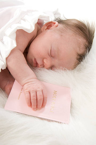 istock Precious Newborn Sleeping Faithfully with Bible 178955953