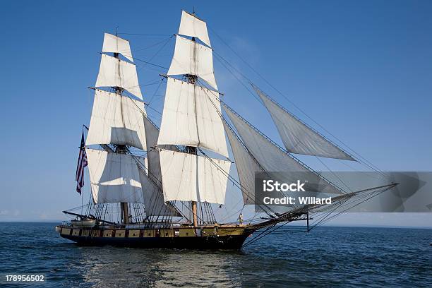Tall Ship On Blue Waters Stock Photo - Download Image Now - American Flag, Antique, Blue