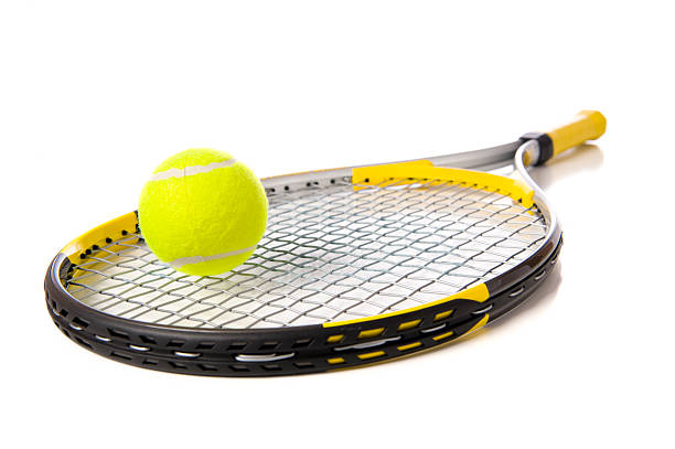 Tennis Racket and ball on white A tennis ball and racket on a white background tennis racket stock pictures, royalty-free photos & images