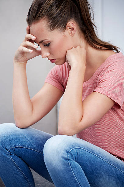 istock Young woman with head in hands 178957988
