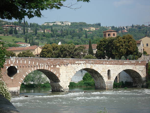 River and ancient Roman bridge, Verona Italy                               
