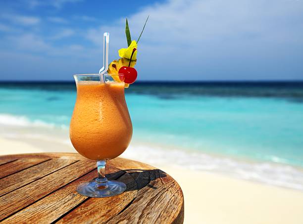istock A fruity cocktail sitting on a wooden table at a beach 178959649