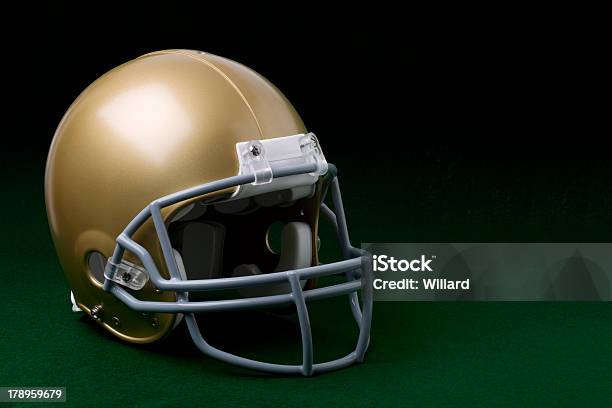 Gold Football Helmet On Green Stock Photo - Download Image Now - Football Helmet, Gold Colored, Dark