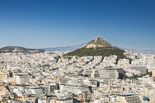 Scenic view of the city of Athens (Greece) with Lycabettus hill in the background and a blue sky with Copy-Space.
